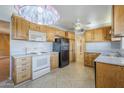 Traditional kitchen featuring light wood cabinets and white appliances at 5437 E Pinchot Ave, Phoenix, AZ 85018