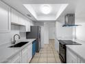Bright kitchen featuring stainless steel appliances, white cabinets, and a skylight at 5504 N 69Th Ave, Glendale, AZ 85303