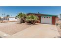 Welcoming exterior featuring a white garage door, rock landscaping and mature palm trees at 7326 E Juanita Ave, Mesa, AZ 85209