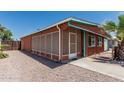 Exterior side view of home showing a screened-in porch and rock landscaping at 7326 E Juanita Ave, Mesa, AZ 85209