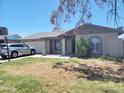 Charming single-story home with a well-maintained lawn and a driveway at 7525 W Turney Ave, Phoenix, AZ 85033