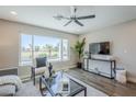 Bright living room featuring a large window with scenic views and modern decor at 7535 W Kimberly Way, Glendale, AZ 85308