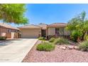 Charming single-story home boasts a well-maintained landscape, tile roof, and a welcoming two-car garage at 7617 E Desert Honeysuckle Dr, Gold Canyon, AZ 85118