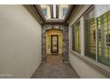 Welcoming front entrance with stone archway, patterned tile, and decorative glass door at 8055 E Jaeger St, Mesa, AZ 85207