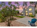 Expansive backyard featuring two patios, a lawn, desert landscaping, and a view of the home at 830 E Gila Ln, Chandler, AZ 85225