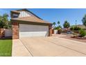 Home featuring a spacious two-car garage, long drive, and landscaped yard at 830 E Gila Ln, Chandler, AZ 85225