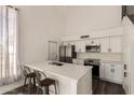 Bright, modern kitchen featuring white cabinets, stainless appliances, and a breakfast bar at 830 E Gila Ln, Chandler, AZ 85225