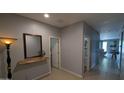 Hallway with neutral walls, decorative mirror and accessories, and light tile flooring at 8419 S 40Th Dr, Laveen, AZ 85339