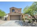 Two-story stucco home featuring a concrete driveway and lush desert landscaping at 8438 W Bajada Rd, Peoria, AZ 85383
