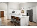 Bright white kitchen with a large island, stainless appliances and plenty of counter space at 8896 E Mescal St, Scottsdale, AZ 85260