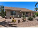 Inviting single-story home showcasing desert landscaping, cacti, and a cozy front patio seating area to enjoy the Arizona sunshine at 932 Leisure World --, Mesa, AZ 85206