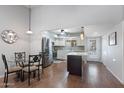 Bright kitchen boasts stainless steel appliances, white cabinets, a center island, and is open to the dining and living areas at 932 Leisure World --, Mesa, AZ 85206