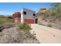Hillside home featuring long driveway leading to a garage and hillside views at 9932 N 16Th E Pl, Phoenix, AZ 85020