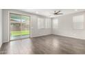 Spacious living room with sliding glass doors, ceiling fan, and tile flooring for easy maintenance at 10059 E Tamery Ave, Mesa, AZ 85212