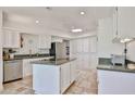 Bright kitchen featuring tiled floors, granite countertops, a skylight, and modern stainless steel appliances at 1035 N Vista Verde --, Litchfield Park, AZ 85340