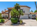 Attractive two-story home with a red tile roof, stone accents, a balcony and desert landscaping at 10386 N 96Th Pl, Scottsdale, AZ 85258