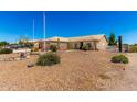Beautiful desert home with xeriscaping, featuring a beige exterior and a tiled roof at 10539 W Tamara Dr, Casa Grande, AZ 85193