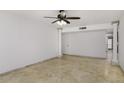 Open living room area with tile floors, columns, and neutral colored walls at 1059 E Broadmor Dr, Tempe, AZ 85282
