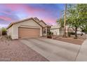 Single-story home with a two-car garage, desert landscaping, and a long driveway at 1060 W Dava Dr, Tempe, AZ 85283
