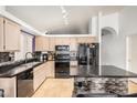 Bright eat-in kitchen featuring black appliances, and mosaic tile accent wall at breakfast bar at 1060 W Dava Dr, Tempe, AZ 85283