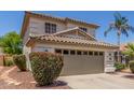 Charming two-story home featuring a tile roof, manicured landscaping, and a spacious two-car garage at 1142 E Mayfield Dr, San Tan Valley, AZ 85143