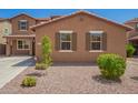 View of the front yard with desert landscaping and a well-maintained lawn at 12029 W Overlin Ln, Avondale, AZ 85323
