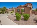 View of the front yard with desert landscaping on a sunny day at 12029 W Overlin Ln, Avondale, AZ 85323