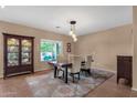 Dining room with a stylish table, chairs, modern light fixture, and decorative rug at 14267 W Crocus Dr, Surprise, AZ 85379
