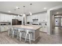 Spacious kitchen features a large island, modern appliances, and sleek countertops at 15070 W Garfield St, Goodyear, AZ 85338