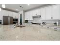 Well-equipped kitchen offers a granite countertop, ample storage, and stainless steel appliances at 15070 W Garfield St, Goodyear, AZ 85338