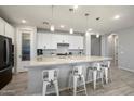 Open kitchen features a large island with seating, perfect for entertaining guests at 15070 W Garfield St, Goodyear, AZ 85338