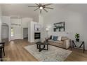 Inviting living room featuring fireplace, wood floors, modern decor, and comfortable seating at 16147 W Central St, Surprise, AZ 85374