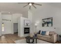 Bright living room with fireplace, wood floors, modern decor, and comfortable seating at 16147 W Central St, Surprise, AZ 85374