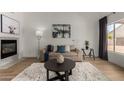 Cozy living room with fireplace, plush rug, comfortable seating, and modern decor at 16147 W Central St, Surprise, AZ 85374
