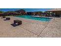 Community pool with seating, a modern deck, and a relaxing environment for residents at 17380 W Jessie Ln, Surprise, AZ 85387