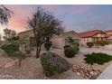 Landscaped front yard with mature trees provides shade and enhances the curb appeal of this home at 17562 W Desert Sage Dr, Goodyear, AZ 85338