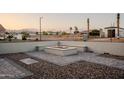Relaxing backyard with a modern fire pit surrounded by stone benches, perfect for entertaining guests at 18125 W Montebello Ct # 67, Litchfield Park, AZ 85340