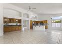 Spacious open layout featuring tile floors, large windows, and a kitchen island at 19010 N 35Th Way, Phoenix, AZ 85050