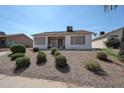 Private backyard offers a covered patio with seating and mature low maintenance landscaping at 1920 E Westchester Dr, Chandler, AZ 85249
