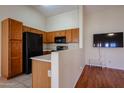 Efficient kitchen features a breakfast bar, black appliances, and stylish cabinetry at 1920 E Westchester Dr, Chandler, AZ 85249