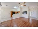 Inviting living room features hardwood floors, a vaulted ceiling with fan and adjoins the kitchen at 1920 E Westchester Dr, Chandler, AZ 85249