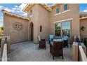 Inviting outdoor patio with stylish wicker furniture, perfect for relaxing and enjoying the neighborhood at 20453 W Daniel Pl, Buckeye, AZ 85396