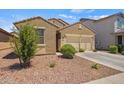 Well-maintained home displaying desert landscaping and a practical two-car garage, ideal for easy living at 21582 W Cocopah St, Buckeye, AZ 85326
