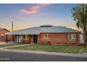 Inviting brick home featuring a neatly kept lawn and classic architectural details at 2225 E Monterosa St, Phoenix, AZ 85016