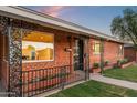 Elegant brick home entrance with decorative ironwork and a well-maintained front yard at 2225 E Monterosa St, Phoenix, AZ 85016