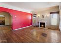 Bright living room showcasing wood floors, a decorative fireplace, and ample natural light at 2230 N 12Th St # Rear, Phoenix, AZ 85006