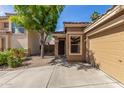 Welcoming single-story home with a tile roof and an attached two-car garage at 2424 E Peach Tree Dr, Chandler, AZ 85249