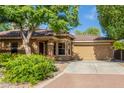 Inviting single-story home with a well-maintained front yard and a convenient two-car garage at 2424 E Peach Tree Dr, Chandler, AZ 85249