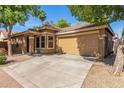 Attractive single-story home showcasing a tile roof and a spacious two-car garage at 2424 E Peach Tree Dr, Chandler, AZ 85249