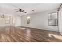 Open-concept living room with attractive wood-look floors and plenty of natural light at 2424 E Peach Tree Dr, Chandler, AZ 85249